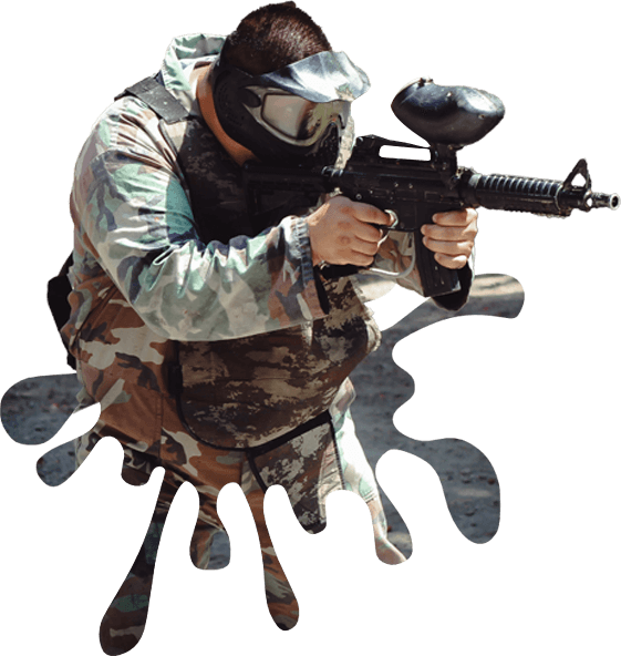 A person in camouflage holding a gun and wearing a mask.